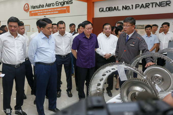 Ông Vương Đình Huệ (áo tím) cùng lãnh đạo TP Hà Nội; Bộ Khoa học và Công nghệ thăm nhà máy sản xuất cấu kiện động cơ máy bay tại Khu CNC Hòa Lạc.